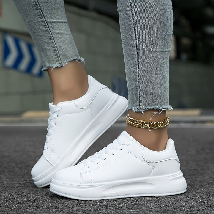 Elegant white low-top women's sneakers, blending chic fashion with everyday comfort.