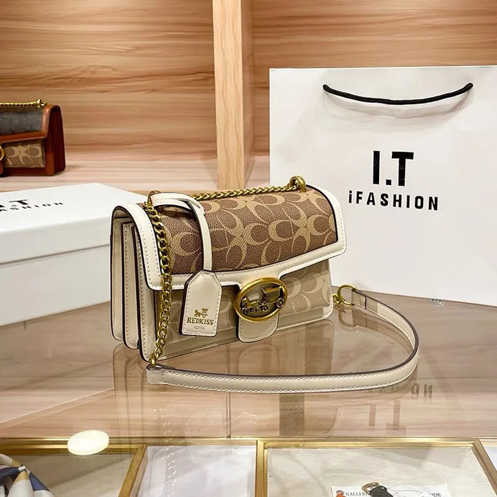 Stylish women's colorblock designer crossbody bag with a sophisticated gold chain.