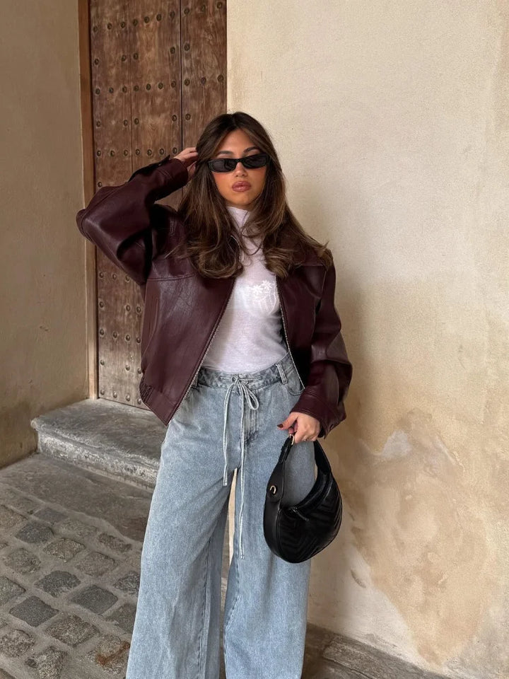 Versatile women's oversized leather jacket in an urban waist-length style, ideal for chic casual wear.