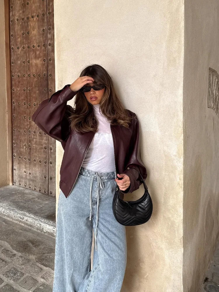 Stylish women's waist-length oversized leather jacket with an urban edge, perfect versatile casual wear.