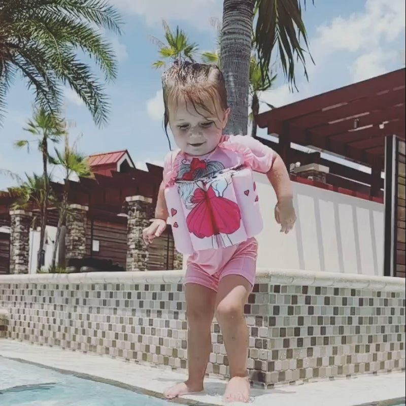 Adjustable children's life jacket, ensuring a snug fit for water play.