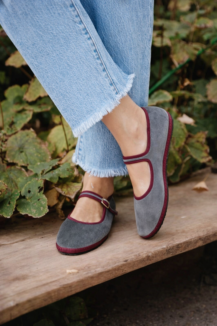 Stylish ladies' round-toe ballet flats in black with an adjustable buckle strap for a secure & elegant fit.