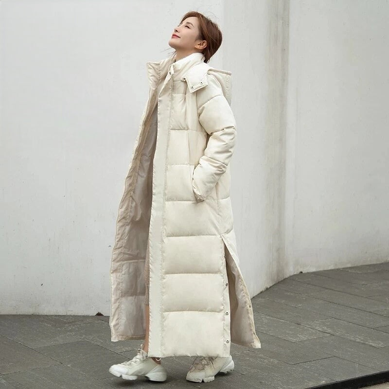 Women's warm padded long winter jacket. Features hood & zipper closure, ideal water-repellent outerwear for cold.