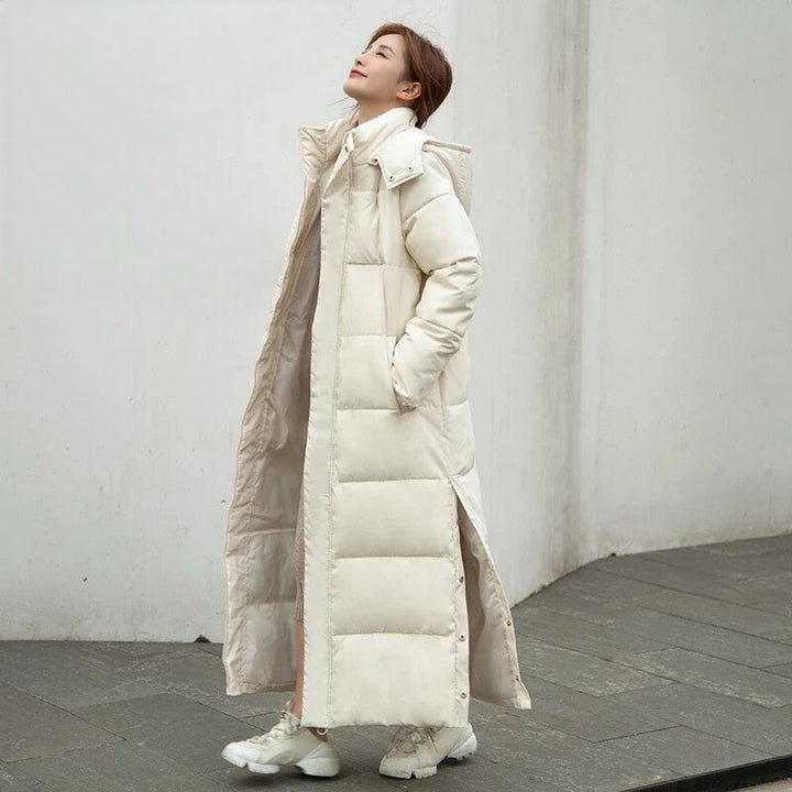 Women's warm padded long winter jacket. Features hood & zipper closure, ideal water-repellent outerwear for cold.