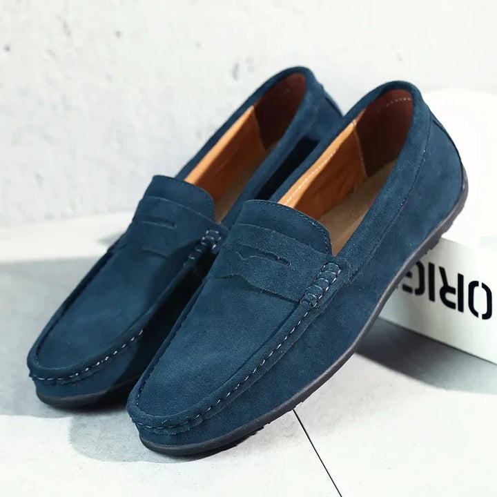 Overhead shot of men's comfortable brown penny loafers, classic slip-on spring/summer smart casual footwear.