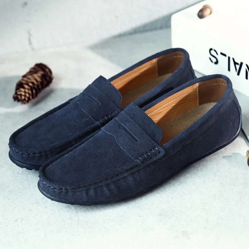 Detail shot of men's penny loafer stitching and sole, highlighting quality slip-on spring casual footwear.