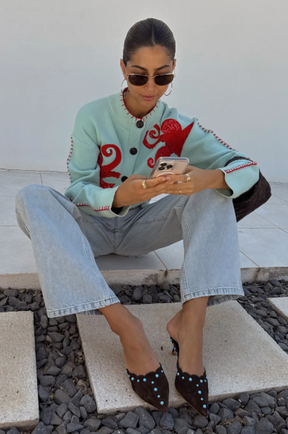 Women's blue coastal style sweater. Unique octopus design, relaxed fit, long sleeve. Perfect for casual wear.