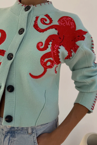 Soft coastal blue women's sweater with a distinctive nautical octopus print. Comfortable, long-sleeve top.