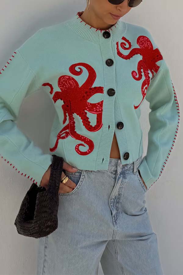Stylish women's blue sweater, a relaxed fit long-sleeve top with a striking nautical octopus.