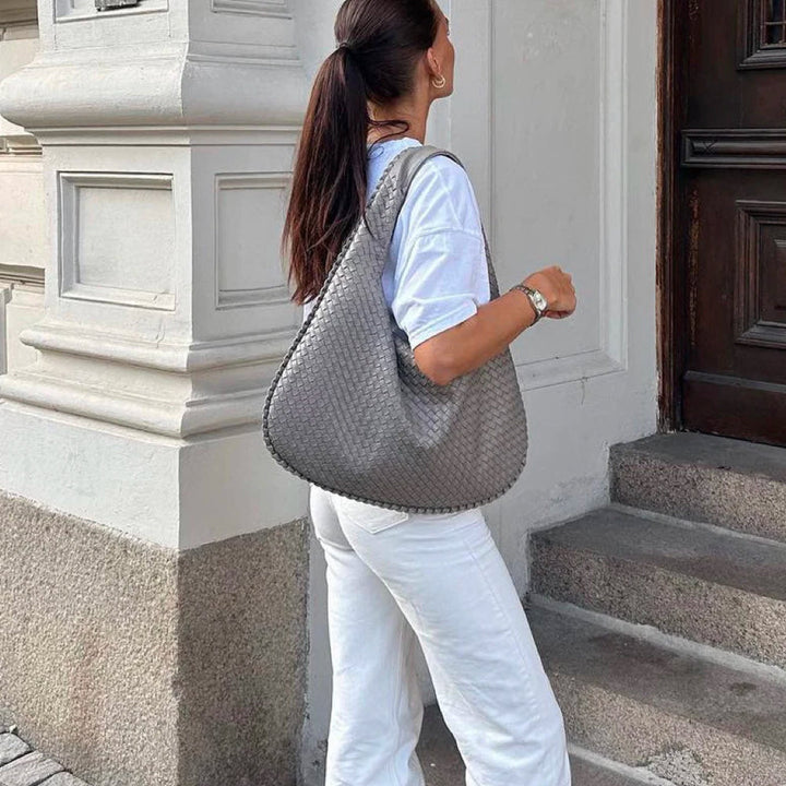 Chic women's shoulder bag with intricate woven design, an elegant vegan leather handbag.