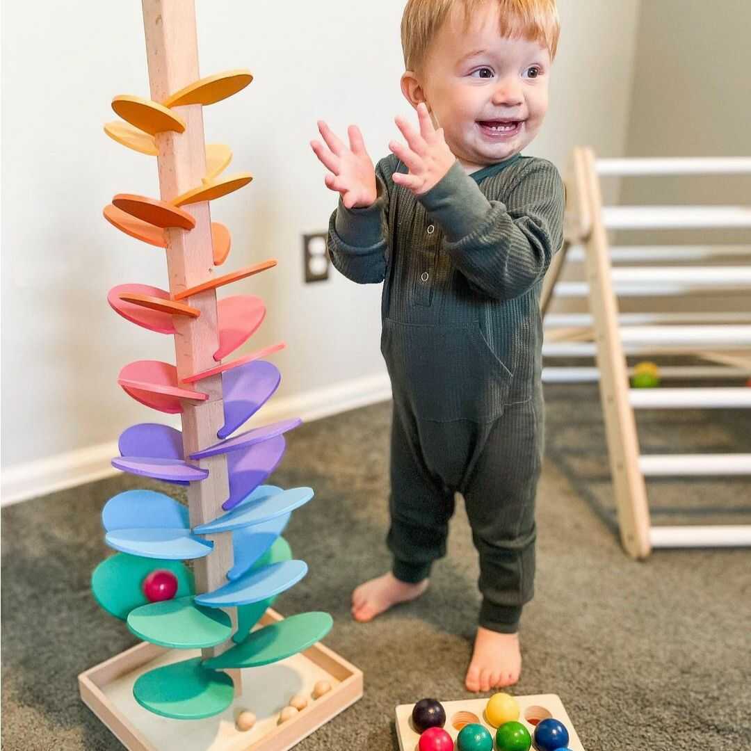 Colorful wooden rainbow sound tower, an educational sensory toy for toddlers. Promotes fine motor skills & early learning.