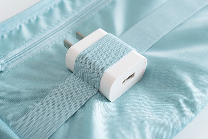 Compact travel organizer for electronics. Store chargers, USBs, and cables in this waterproof tech bag.