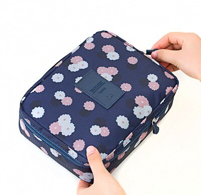 Women's compact waterproof travel organizer for makeup & beauty essentials, dark blue floral design.