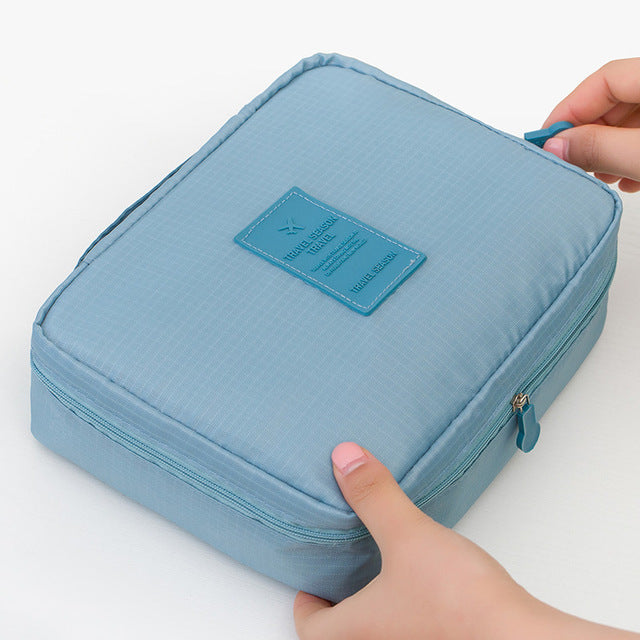 Elegant dark blue floral waterproof makeup travel organizer for women, compact & secure beauty storage.