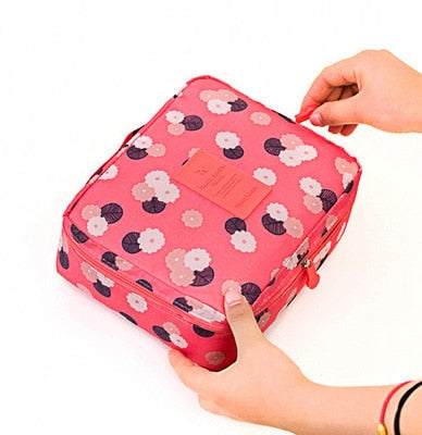 Compact dark blue floral waterproof makeup travel bag, perfect for women's beauty on the go.