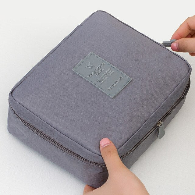 Women's compact waterproof travel bag for makeup, dark blue floral print. Bonus mini cosmetic case.