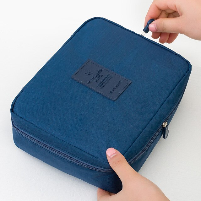 Dark blue floral waterproof beauty storage organizer for women, compact & ideal for travel toiletries.