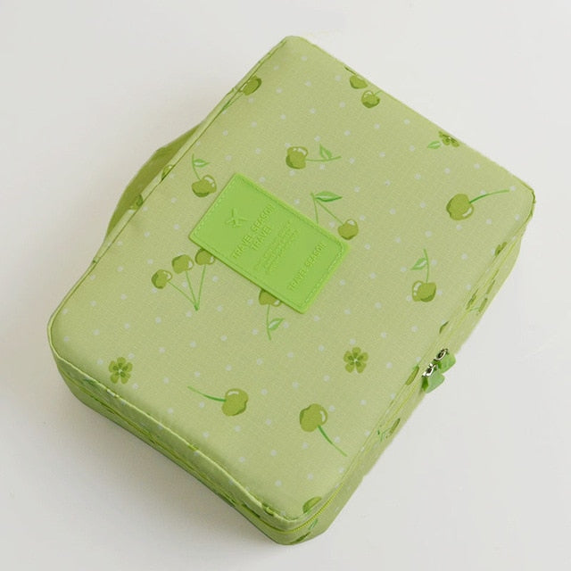 Compact waterproof makeup travel organizer, dark blue flowers, women's essential beauty accessory.