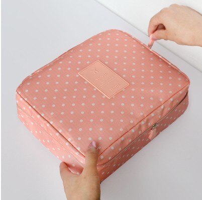 Portable waterproof makeup travel bag for women with dark blue flowers. Ideal for cosmetics & toiletries.