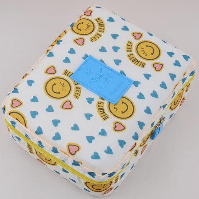 Women's dark blue floral waterproof makeup travel organizer, a compact accessory for beauty storage.