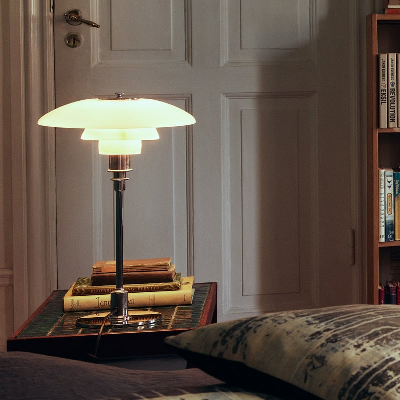 Contemporary Danish designer table lamp with warm LED light, sleek Scandinavian form, amber finish, and premium glass.