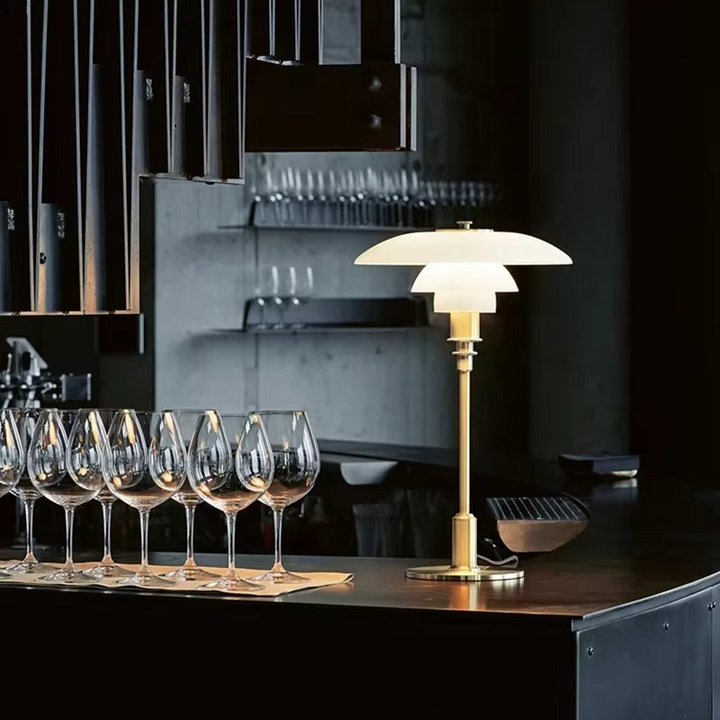 Contemporary Danish designer table lamp with warm LED light, sleek Scandinavian form, amber finish, and premium glass.