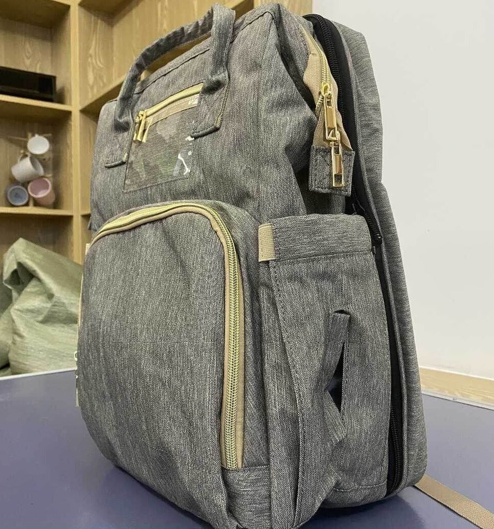 Secure & compact convertible diaper bag backpack, featuring a foldable bassinet for safe resting anywhere. New parents.