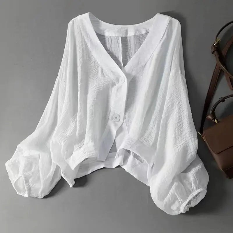 Women's relaxed batwing sleeve blouse in cotton linen with elegant front button detail, perfect for casual or elegant wear.