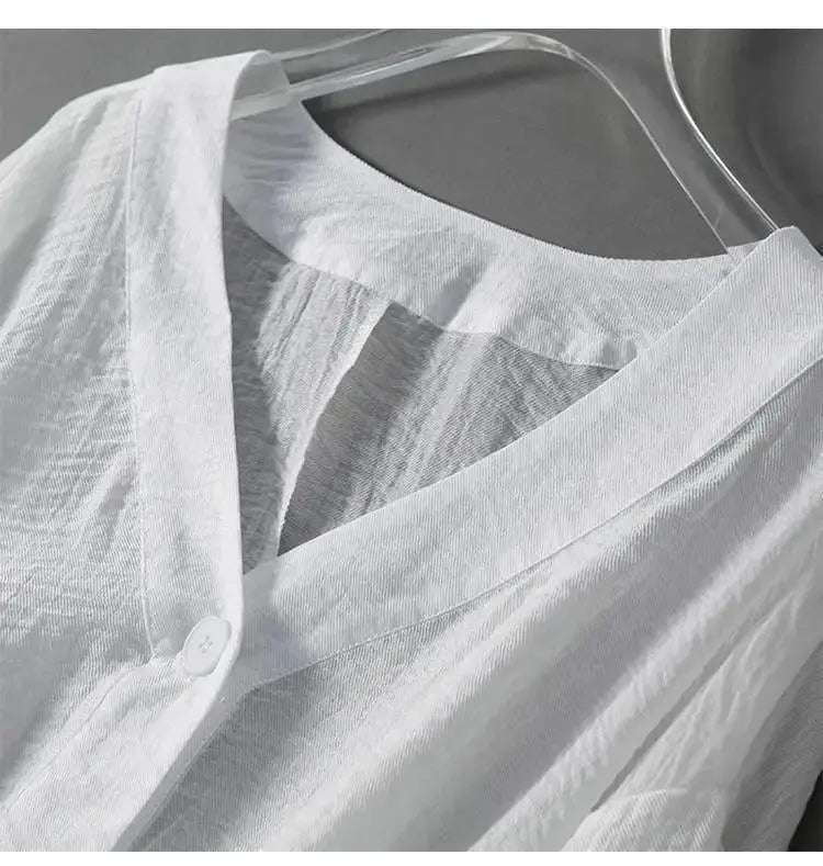 Loose-fit women's cotton linen blouse with stylish batwing sleeves and subtle button detailing, versatile for all seasons.