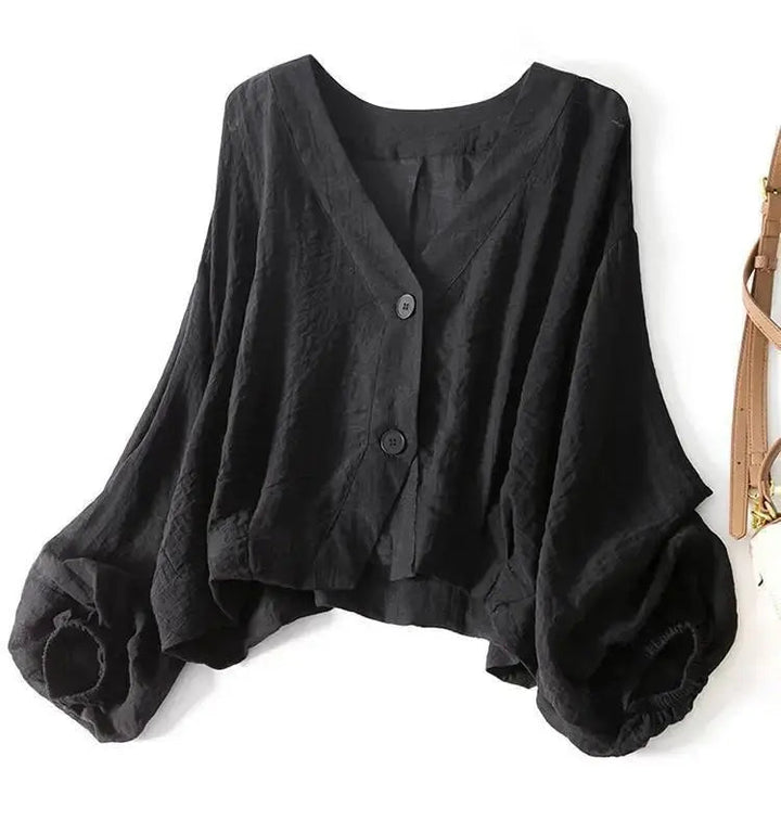 Stylish women's relaxed fit blouse in cotton linen, showcasing unique batwing sleeves and chic front button accents.