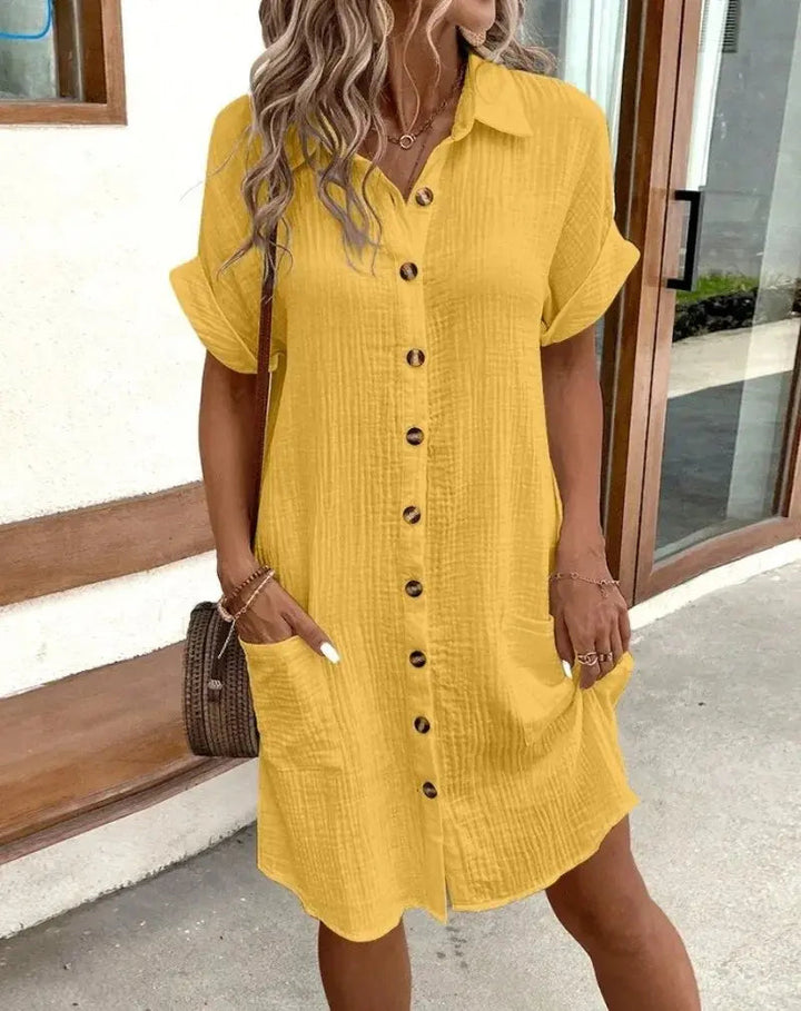 Women's collared short-sleeve shirtdress. Button-down design with functional patch pockets for a casual look.