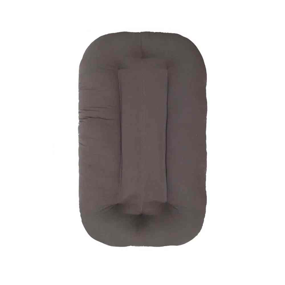 Cozy portable baby sleeping nest lounger for newborns, providing a safe and comfortable infant bed made of soft cotton.