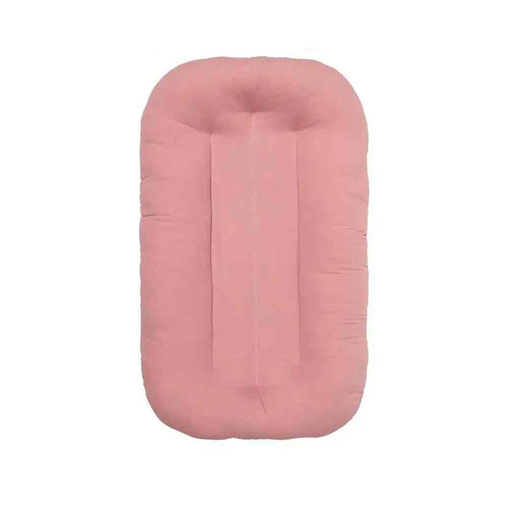 Comfortable baby sleeping nest lounger for newborns, a soft cotton infant bed ensuring safe, cozy sleep at home or travel.