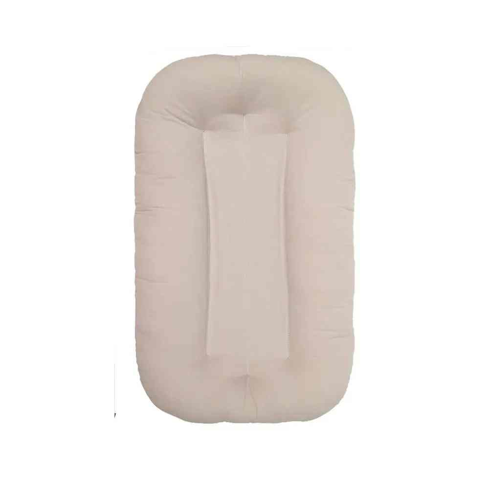 Soft cotton baby sleeping nest lounger, a comfortable and safe infant bed for newborn care, ideal portable baby gift.