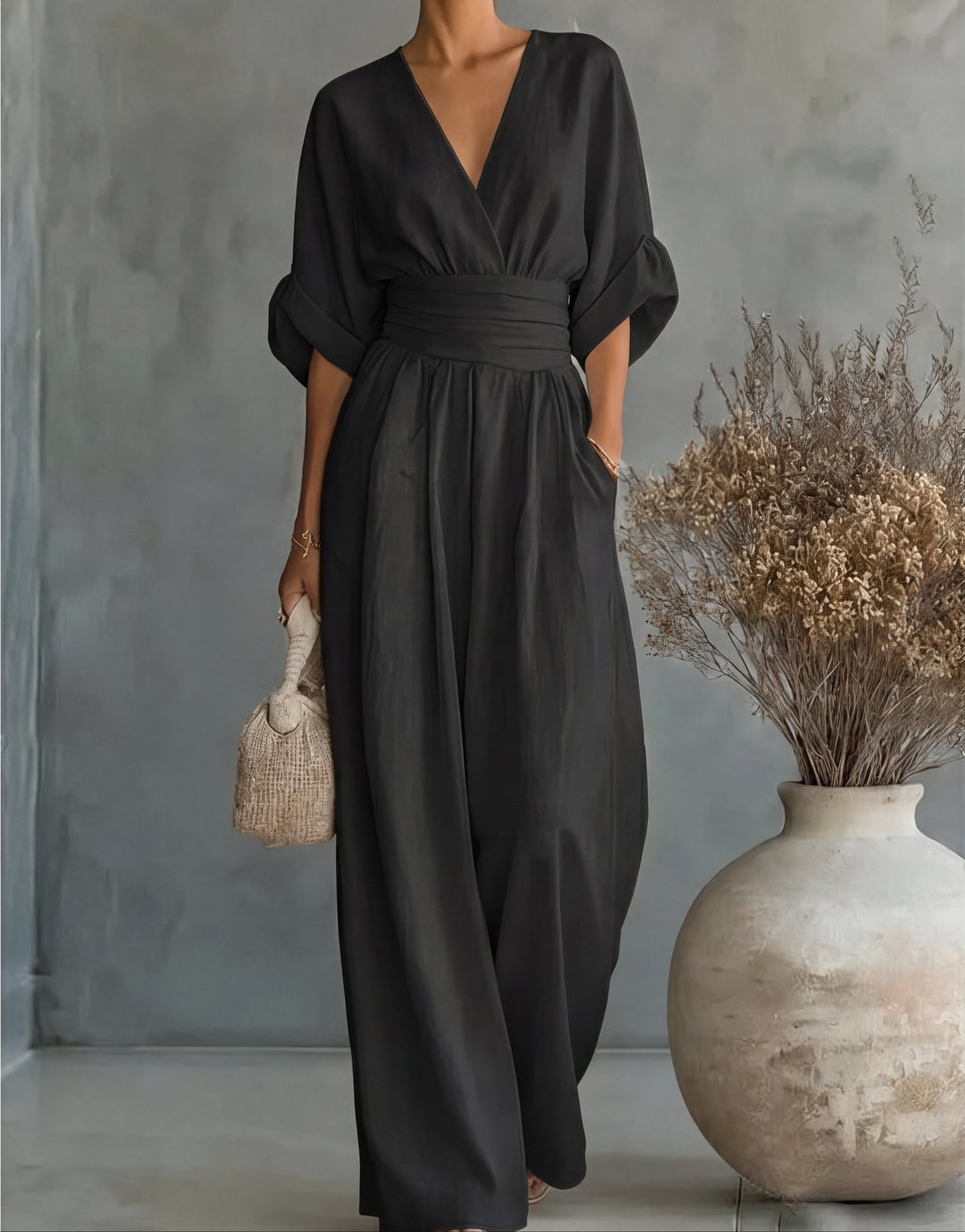 Sleek women's wide-leg jumpsuit, an elegant wrap-style one-piece for year-round chic apparel.