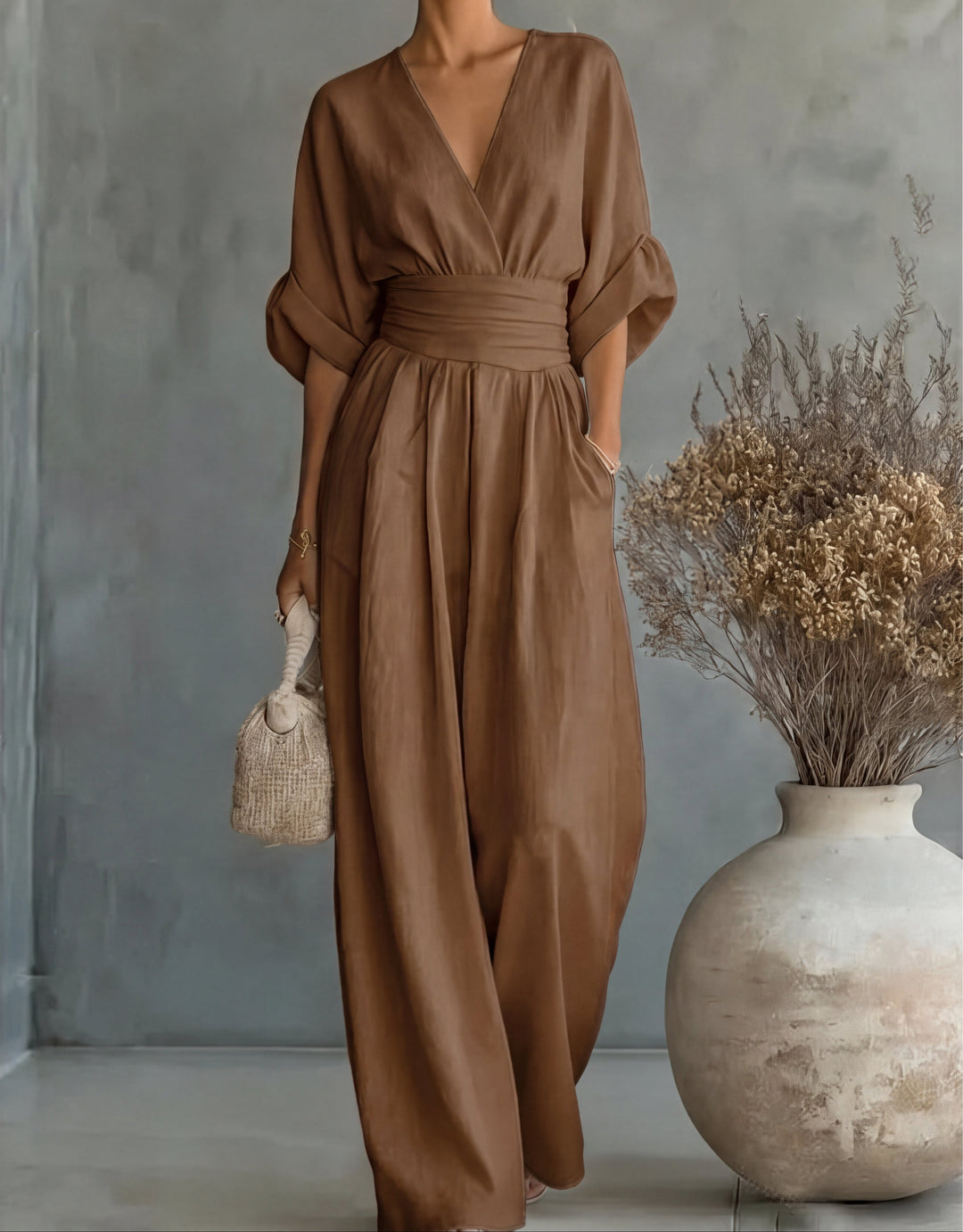 Polished women's wide-leg jumpsuit, elegant wrap style, ideal for versatile chic spring fashion.