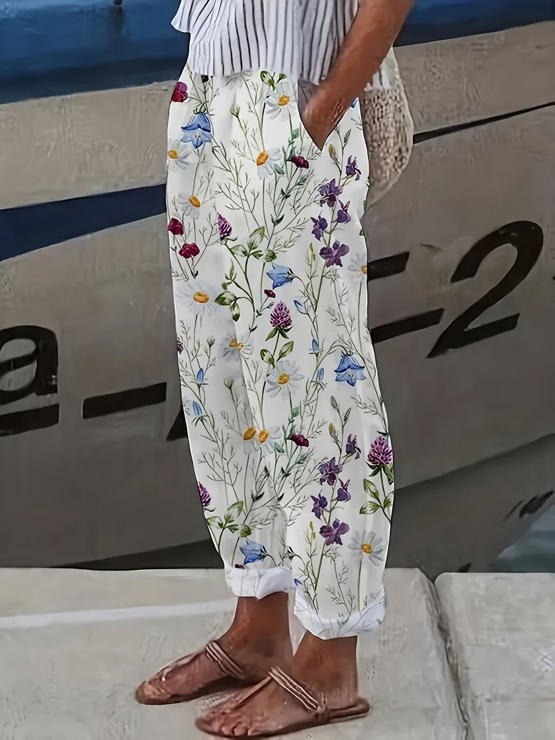 Women's white floral summer trousers, flowing and breathable. Perfect lightweight relaxed fit pants for vacation or casual wear.
