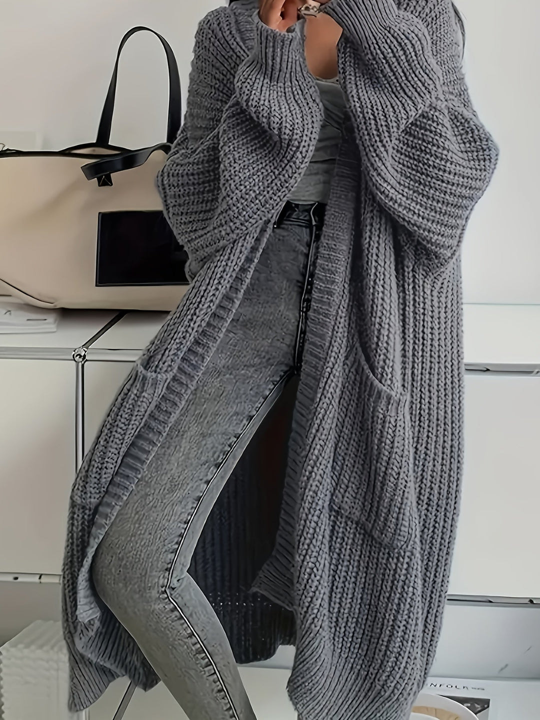 Women's chic V-neck button-front cardigan sweater, soft knit for cosy autumn fashion.