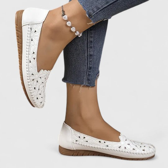 White women's flat slip-on sandals, a chic and comfortable choice for casual summer days.