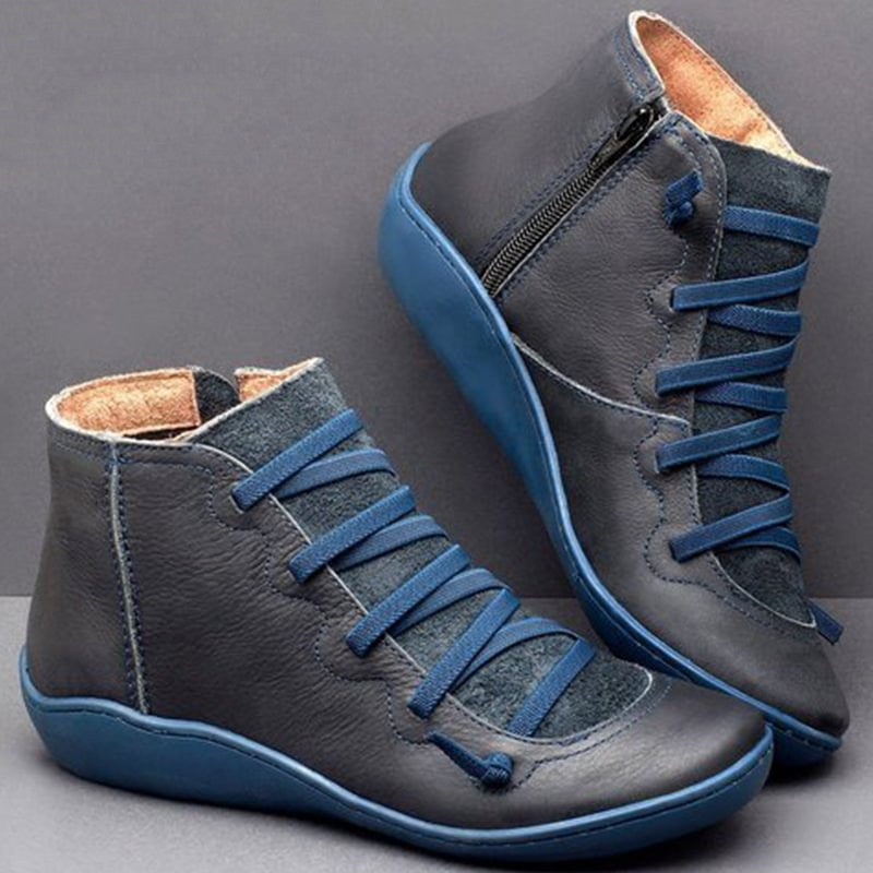 Black PU leather orthopaedic ankle boots for women, featuring a convenient zip & flat heel.
