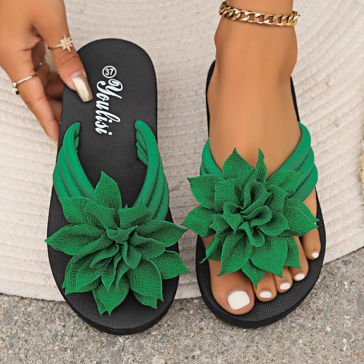 Elegant women's platform flip-flops, floral accent, offering a comfortable wide fit.