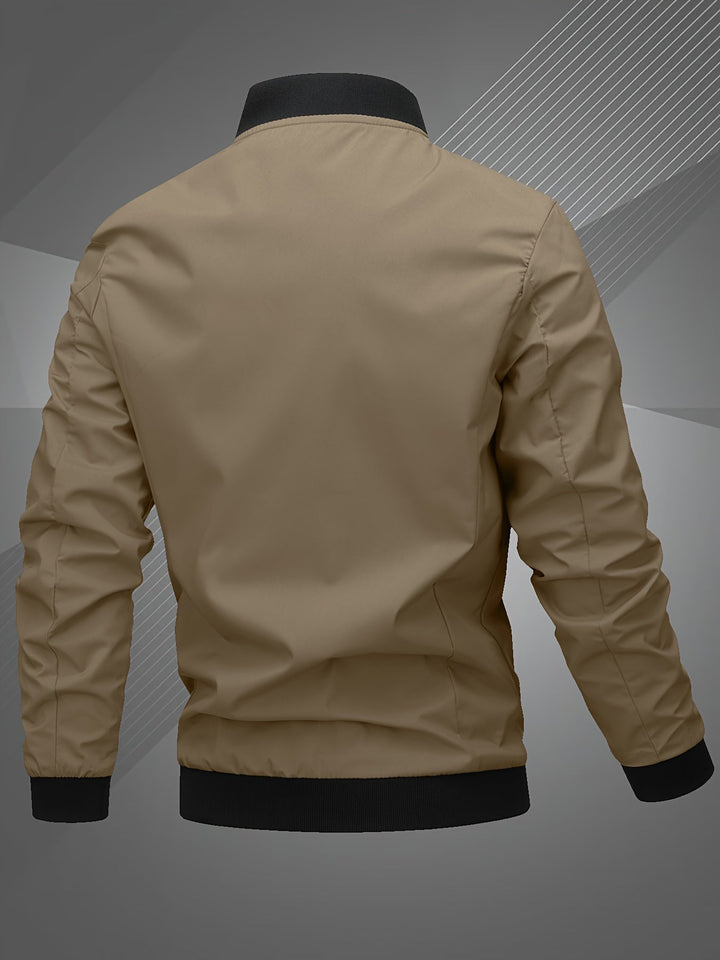 Detail shot of the zip-up closure and subtle logo on a men's versatile bomber jacket.