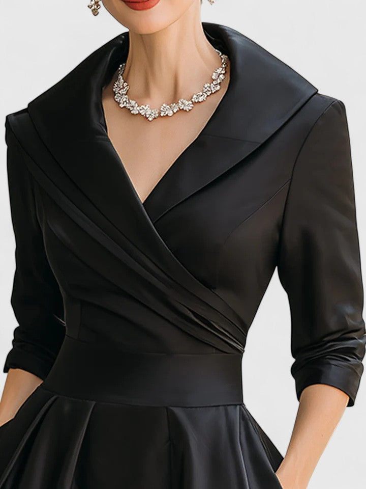 Close-up of the elegant wrap bodice & short sleeves on a versatile women's pleated midi dress.