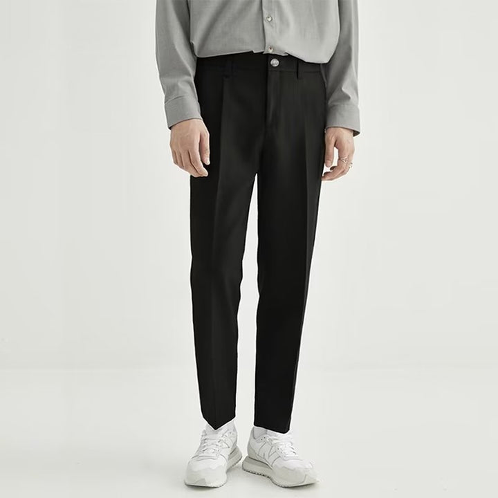 Black men's high-waisted pleated cropped pants, modern smart casual dress trousers.