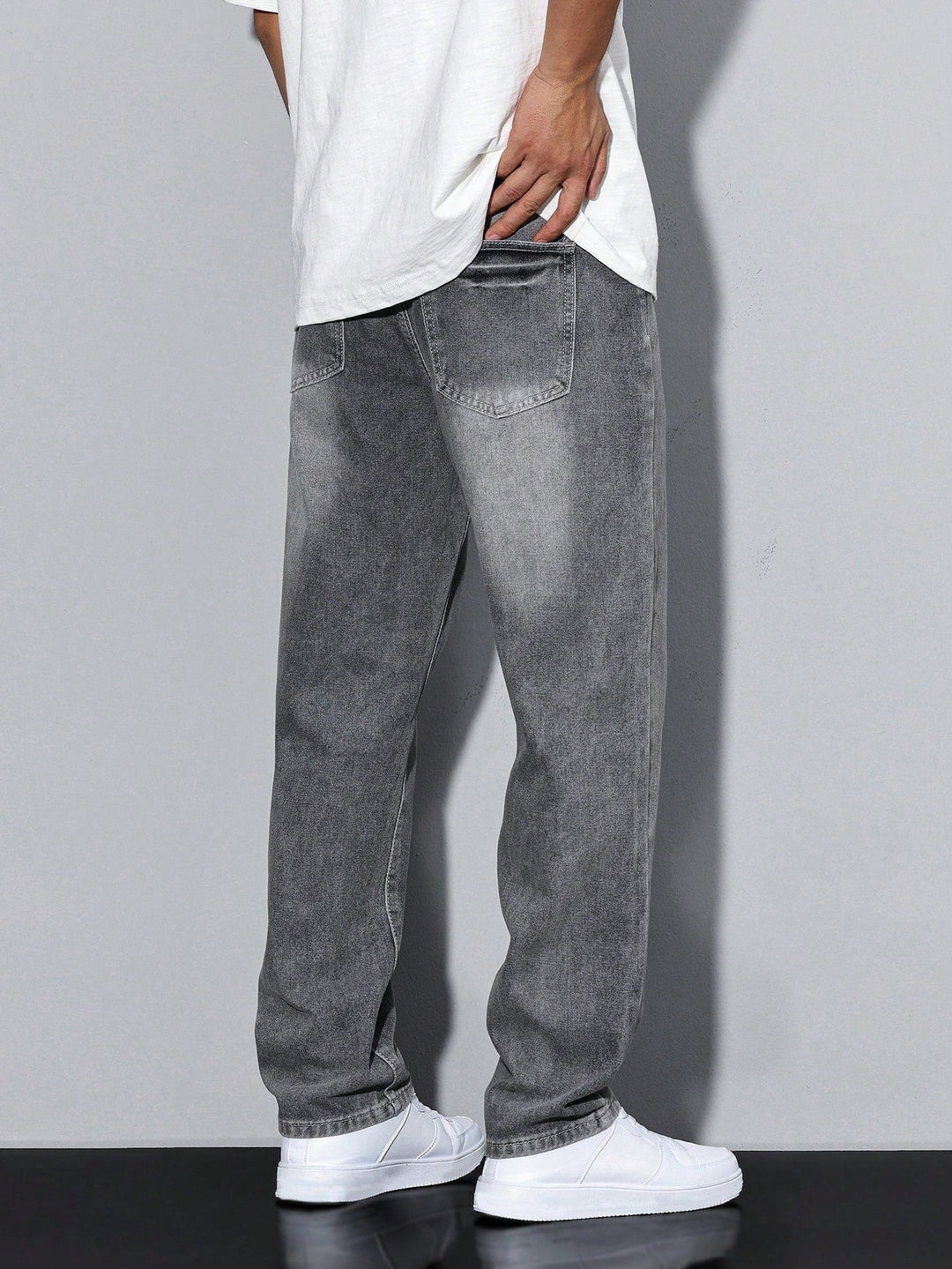 Back view of men's straight leg washed denim jeans, highlighting comfortable loose fit.