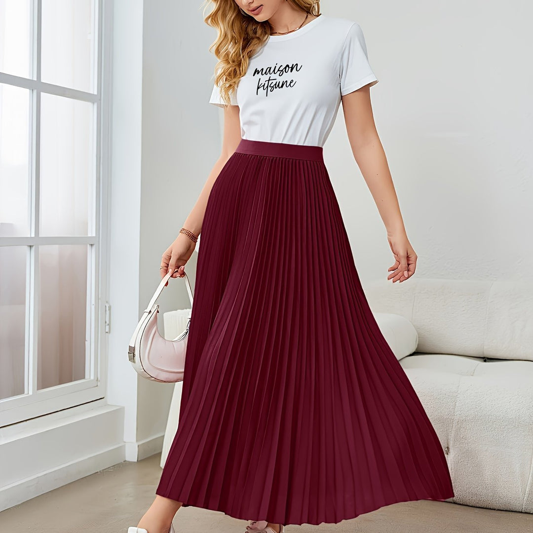Full length shot of a woman in a flowy pleated midi skirt, showcasing its elegant style & elastic waist.