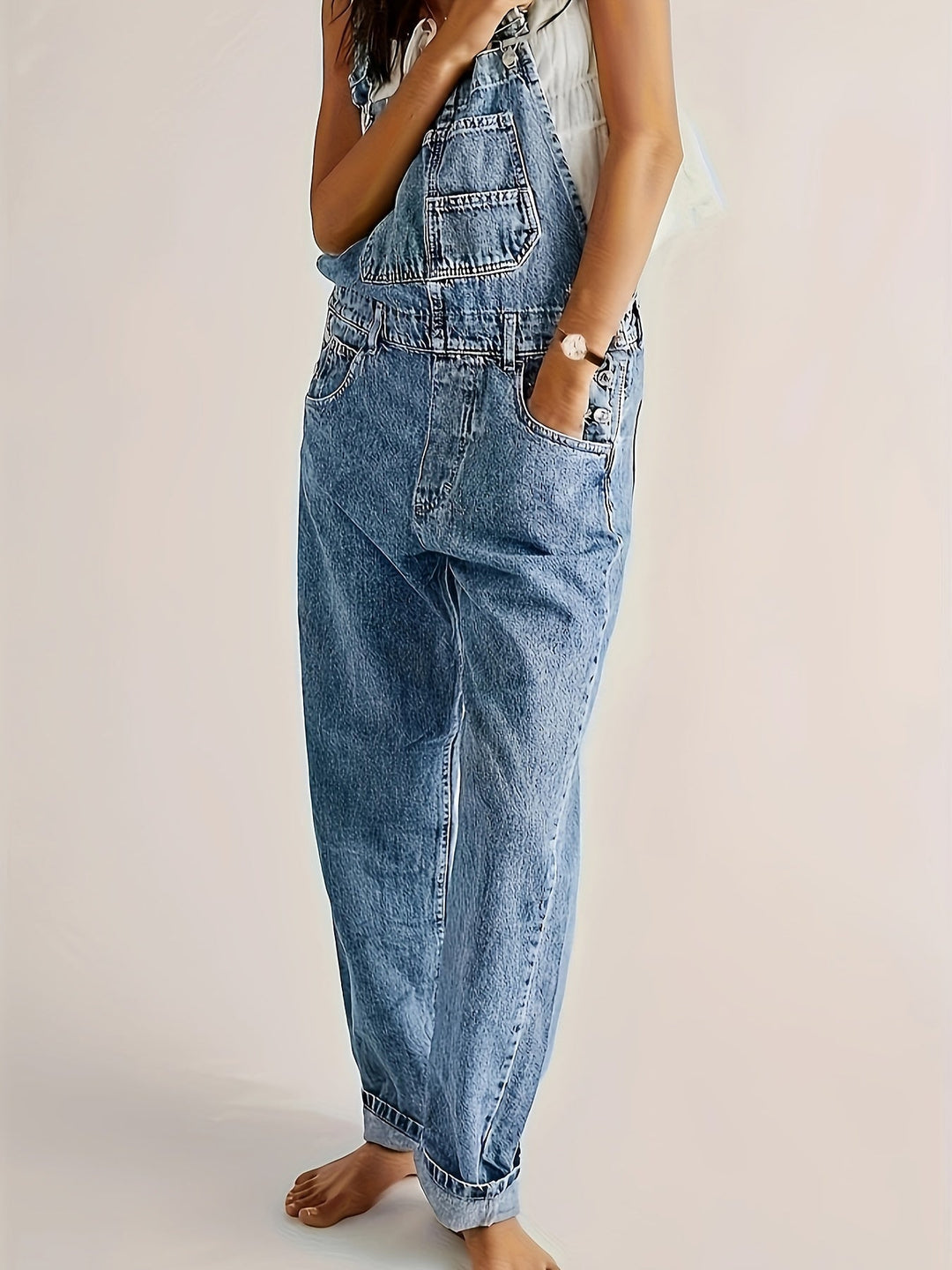 Women's denim dungarees, loose fit overalls styled with a white tee, perfect casual fashion look.
