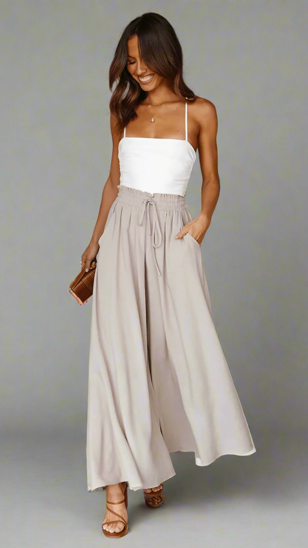 Comfortable pleated wide-leg trousers with elastic waist, ready for versatile styling.