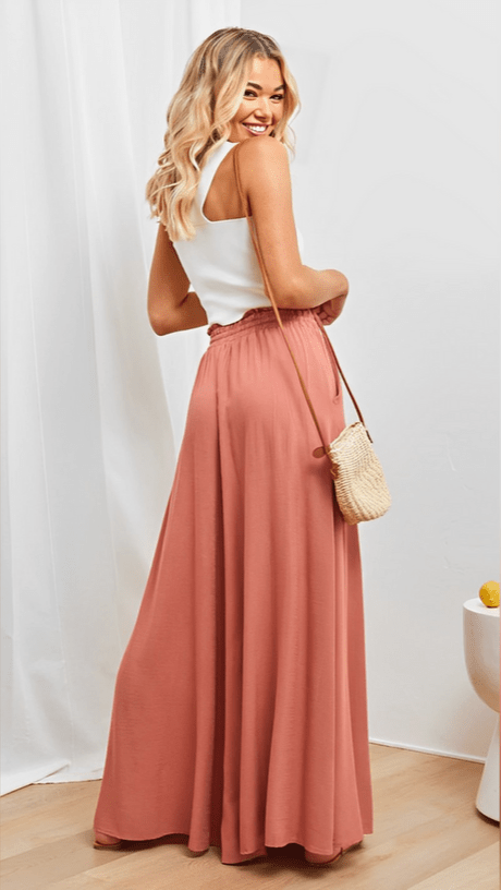 Close-up of Lily wide-leg trousers hem, displaying quality fabric & elegant drape.