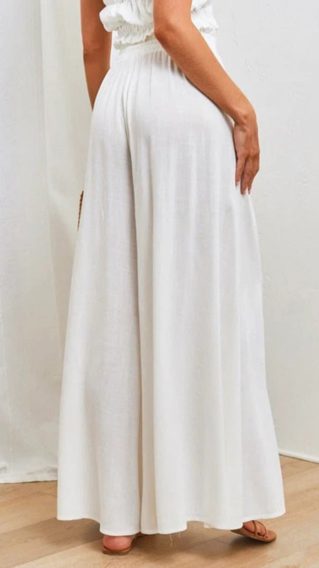 Elegant woman in comfortable wide-leg trousers with elastic waist; versatile for seasons.